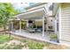 Covered patio with outdoor seating, grill, and TV, perfect for entertaining or relaxing at 1916 Pine Mountain Rd, Charlotte, NC 28214
