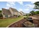 Expansive backyard featuring a gazebo, brick patio, raised garden beds, and well-maintained lawn at 2041 Topaz Plz, Davidson, NC 28036