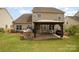 Backyard view featuring a pergola-covered patio, outdoor kitchen, lush lawn, and well-maintained landscaping at 2041 Topaz Plz, Davidson, NC 28036
