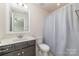 This bathroom features a vanity with a mirror, a toilet, and a shower with a curtain at 2041 Topaz Plz, Davidson, NC 28036