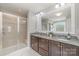 Bright bathroom with dual sinks, a glass enclosed shower, and modern fixtures at 2041 Topaz Plz, Davidson, NC 28036