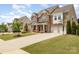 Beautiful two-story brick home with a well-manicured lawn and a three-car garage at 2041 Topaz Plz, Davidson, NC 28036