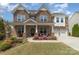 Charming brick home with a covered front porch, well-kept lawn, and an attached garage at 2041 Topaz Plz, Davidson, NC 28036