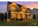 Stunning home featuring brick facade, well-lit landscaping, and charming porch, creating welcoming curb appeal at 2041 Topaz Plz, Davidson, NC 28036