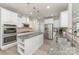 Bright kitchen features white cabinets, gray countertops, an island, and stainless steel appliances at 2041 Topaz Plz, Davidson, NC 28036