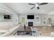 Bright living room featuring fireplace, ceiling fan, and large windows; great for entertaining and relaxation at 2041 Topaz Plz, Davidson, NC 28036