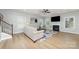 Bright living room features a fireplace, ceiling fan, multiple windows, and a floral area rug at 2041 Topaz Plz, Davidson, NC 28036