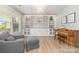 Charming living room with custom built-in shelving, cabinets, a piano, and comfortable seating at 2041 Topaz Plz, Davidson, NC 28036
