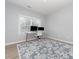Bright home office with a large window, modern desk, comfortable chair and stylish rug at 2041 Topaz Plz, Davidson, NC 28036