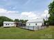 Wide view of backyard featuring a pool with a fence and attached covered deck with white exterior at 2054 Hickory Hills Dr, Denver, NC 28037