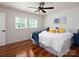 Serene bedroom with hardwood floors, ceiling fan, and natural light at 2054 Hickory Hills Dr, Denver, NC 28037