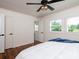 Bright bedroom featuring a ceiling fan, hardwood floors, and white trim for a clean, modern look at 2054 Hickory Hills Dr, Denver, NC 28037