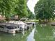Beautiful view of boats docked in a peaceful canal lined with lush trees, offering serene waterfront living at 2054 Hickory Hills Dr, Denver, NC 28037