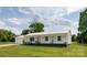 Charming single-story home with a metal roof, inviting front porch, and well-maintained lawn at 2054 Hickory Hills Dr, Denver, NC 28037