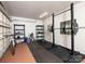 Bright garage converted into a gym with work out rack, shelving, and equipment on rubber flooring at 2054 Hickory Hills Dr, Denver, NC 28037
