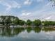 Expansive lake view showcasing waterfront homes with docks under a sunny sky, ideal for relaxation and recreation at 2054 Hickory Hills Dr, Denver, NC 28037