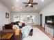 Bright living room with hardwood floors, a ceiling fan, and large glass doors leading to outdoor living at 2054 Hickory Hills Dr, Denver, NC 28037