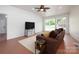 Finished room with windows, recessed lighting, ceiling fan and a comfortable brown sofa at 2054 Hickory Hills Dr, Denver, NC 28037