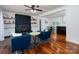 Bright living room features a brick fireplace, hardwood floors, and access to dining area at 2054 Hickory Hills Dr, Denver, NC 28037