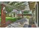 Backyard patio with pergola, stone floor, and view of garage with garden at 2126 Norton Rd, Charlotte, NC 28207