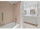 Bathroom with a combination tub and shower, tiled walls, and a double sink vanity in the background at 2126 Norton Rd, Charlotte, NC 28207