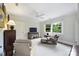 Cozy bedroom featuring two armchairs, a TV, a ceiling fan, and a large window overlooking the outdoor scenery at 2126 Norton Rd, Charlotte, NC 28207