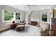 Sunlit bedroom with a ceiling fan, a window with tree views, and two comfortable armchairs for relaxing at 2126 Norton Rd, Charlotte, NC 28207