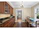 Inviting dining area featuring dark wood floors, classic built-in cabinets, and ample natural light from a window at 2126 Norton Rd, Charlotte, NC 28207