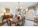 Elegant dining room featuring a chandelier, hardwood floors, and a large wooden dining table at 2126 Norton Rd, Charlotte, NC 28207