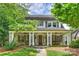 Charming two-story home featuring a welcoming front porch with stately columns and a meticulously maintained lawn at 2126 Norton Rd, Charlotte, NC 28207