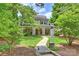 Inviting two-story home with a stone pathway leading to a covered porch, surrounded by lush landscaping at 2126 Norton Rd, Charlotte, NC 28207