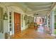 Inviting front porch featuring wicker furniture, stylish lanterns, and a beautiful wooden door at 2126 Norton Rd, Charlotte, NC 28207