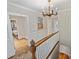 Bright hallway featuring classic wood trim, staircase, and access to rooms at 2126 Norton Rd, Charlotte, NC 28207