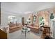 Bright and airy living room with hardwood floors, a glass coffee table, and a view into the dining room at 2126 Norton Rd, Charlotte, NC 28207