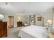 Bright main bedroom boasts natural light from large windows, neutral walls and carpet, and furniture at 2126 Norton Rd, Charlotte, NC 28207