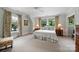 Bright main bedroom boasts natural light from large windows, neutral walls and carpet, and ensuite access at 2126 Norton Rd, Charlotte, NC 28207