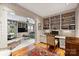 Home office with built-in shelving, desk space, and views into the living room at 2126 Norton Rd, Charlotte, NC 28207
