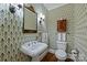 Elegant powder room featuring patterned wallpaper, vintage mirror, and pedestal sink at 2126 Norton Rd, Charlotte, NC 28207
