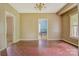 Open dining space with hardwood floors and a view into another room with a bed at 252 7Th Se St, Hickory, NC 28602