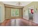 Dining area with hardwood floors and a bright window, adjacent to the red kitchen at 252 7Th Se St, Hickory, NC 28602