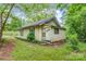 Exterior showing a small home with green trim and surrounded by grass and trees at 252 7Th Se St, Hickory, NC 28602