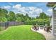 Well-maintained lawn with outdoor seating area and modern fire pit feature at 2625 Rea Pond Ct, Charlotte, NC 28226