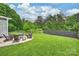 Large green backyard with outdoor seating and fire pit, perfect for entertaining at 2625 Rea Pond Ct, Charlotte, NC 28226