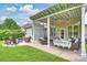 Backyard with a covered patio featuring a swing, comfortable seating, and a fire pit area at 2625 Rea Pond Ct, Charlotte, NC 28226