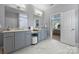 Bathroom vanity with double sinks, a makeup counter, marble floors, and view into the bedroom at 2625 Rea Pond Ct, Charlotte, NC 28226