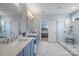 Bright bathroom featuring a double vanity, marble floors, and glass enclosed shower at 2625 Rea Pond Ct, Charlotte, NC 28226
