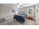 Bedroom featuring metal frame bed with blue bedding, two windows, and carpet flooring at 2625 Rea Pond Ct, Charlotte, NC 28226