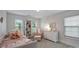 Bright bedroom with white furnishings, a daybed, chair, and a bookshelf beside the windows at 2625 Rea Pond Ct, Charlotte, NC 28226