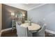 Elegant dining room with gray accent wall, stylish mirror, and round table with seating for up to six at 2625 Rea Pond Ct, Charlotte, NC 28226