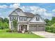 Charming two-story home with manicured lawn, stone accents, three car garage, and covered front porch at 2625 Rea Pond Ct, Charlotte, NC 28226